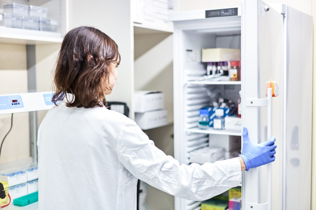 Hospital employee opening a refrigerator