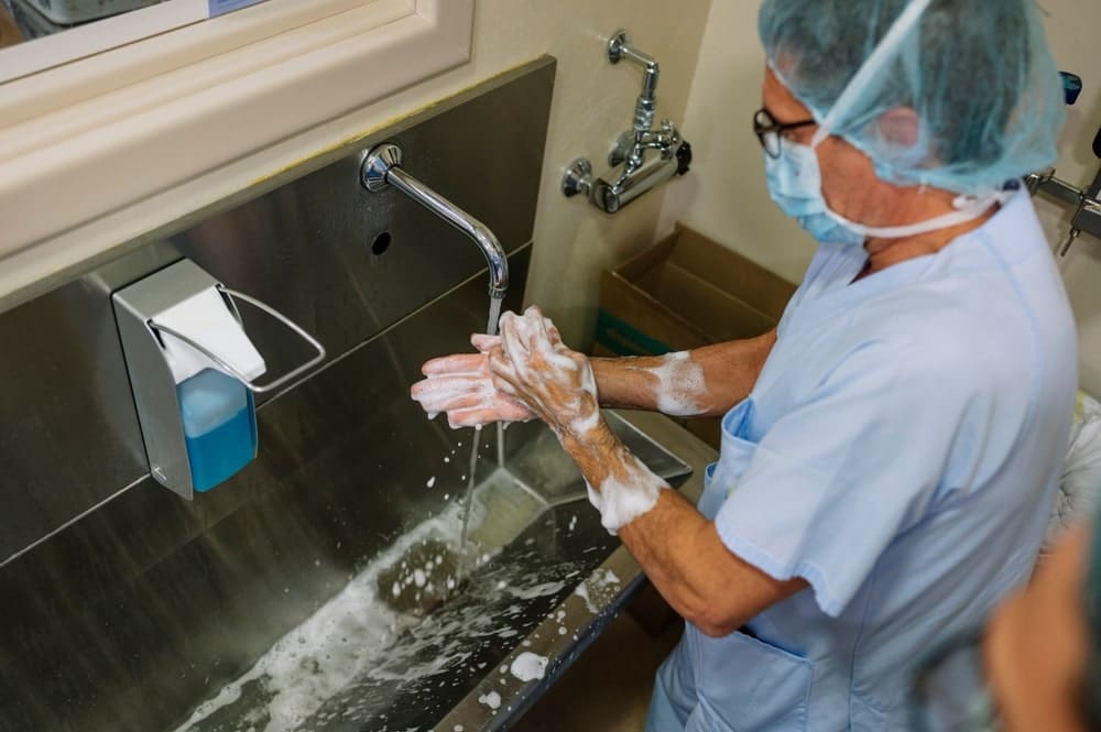 doctor washing hands as part of hand hygiene compliance